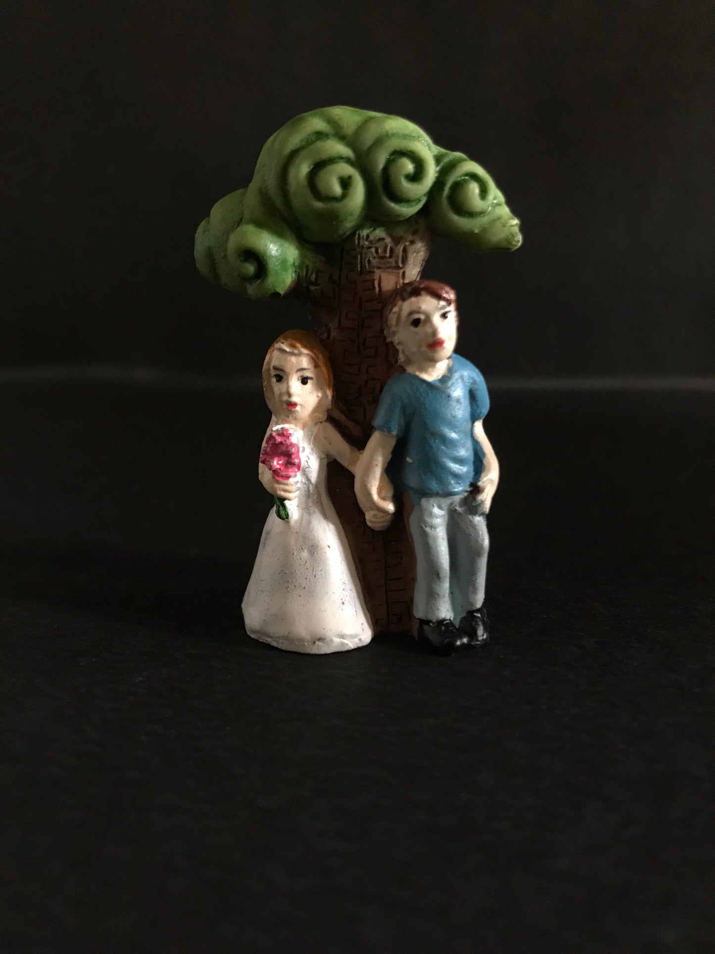 Newly wed young couple under tree.