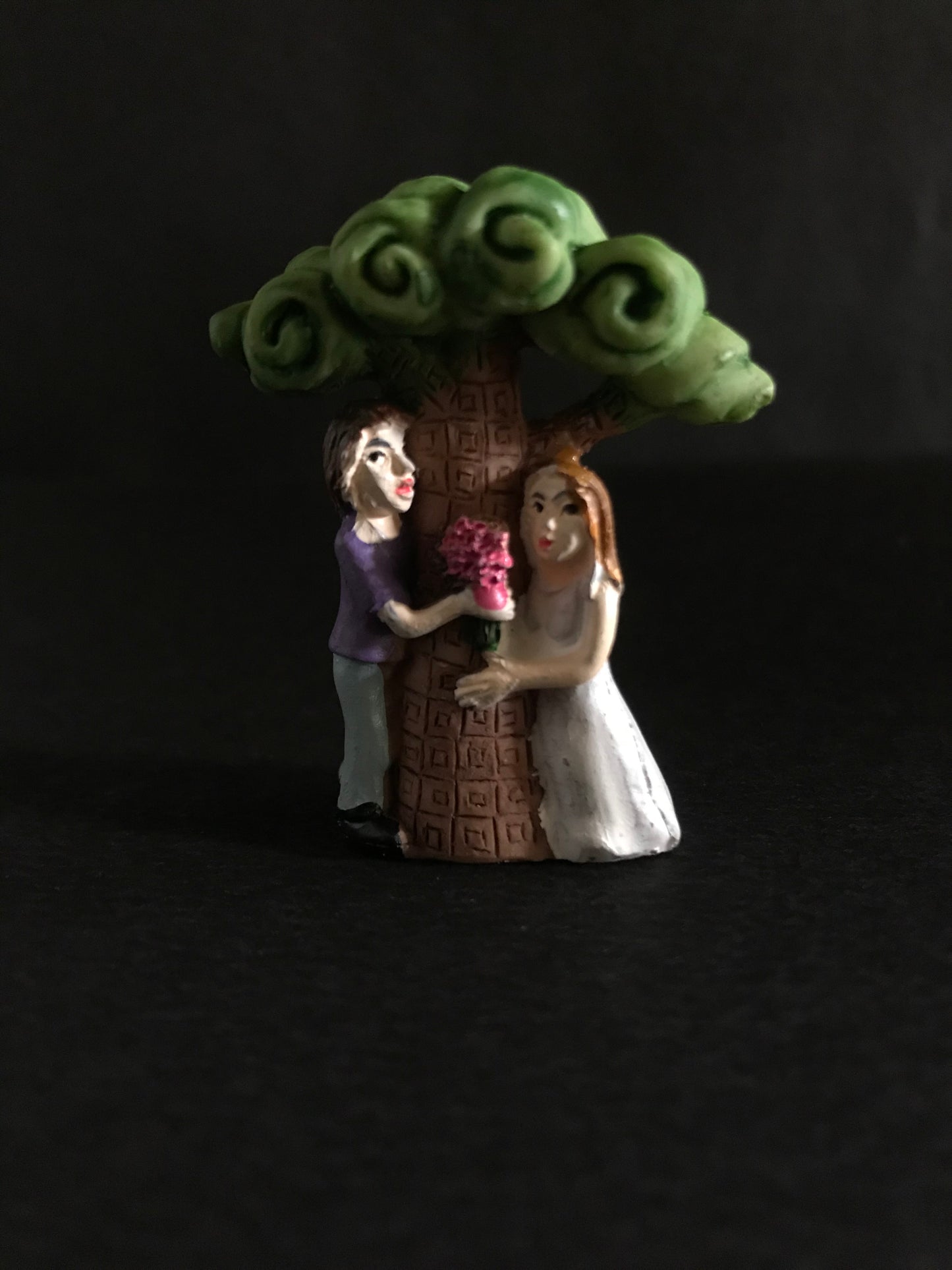 Newly wed young couple under tree.