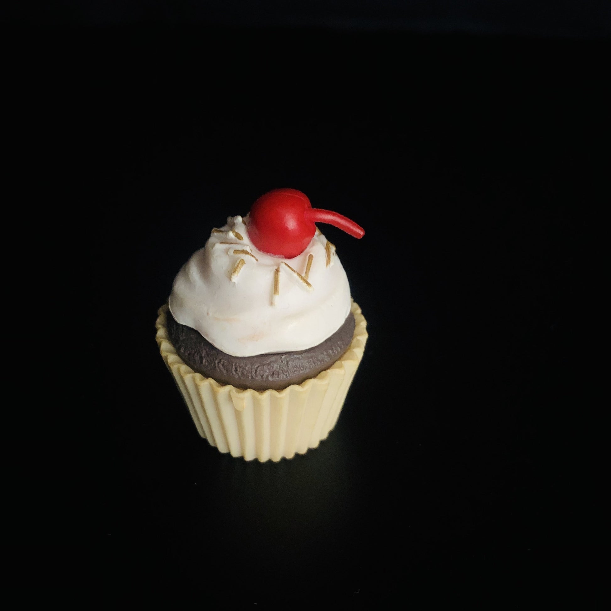 brown cupcake, whipped cream, cherry